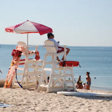 Lifeguard scanning the beach ensuring patron safety 